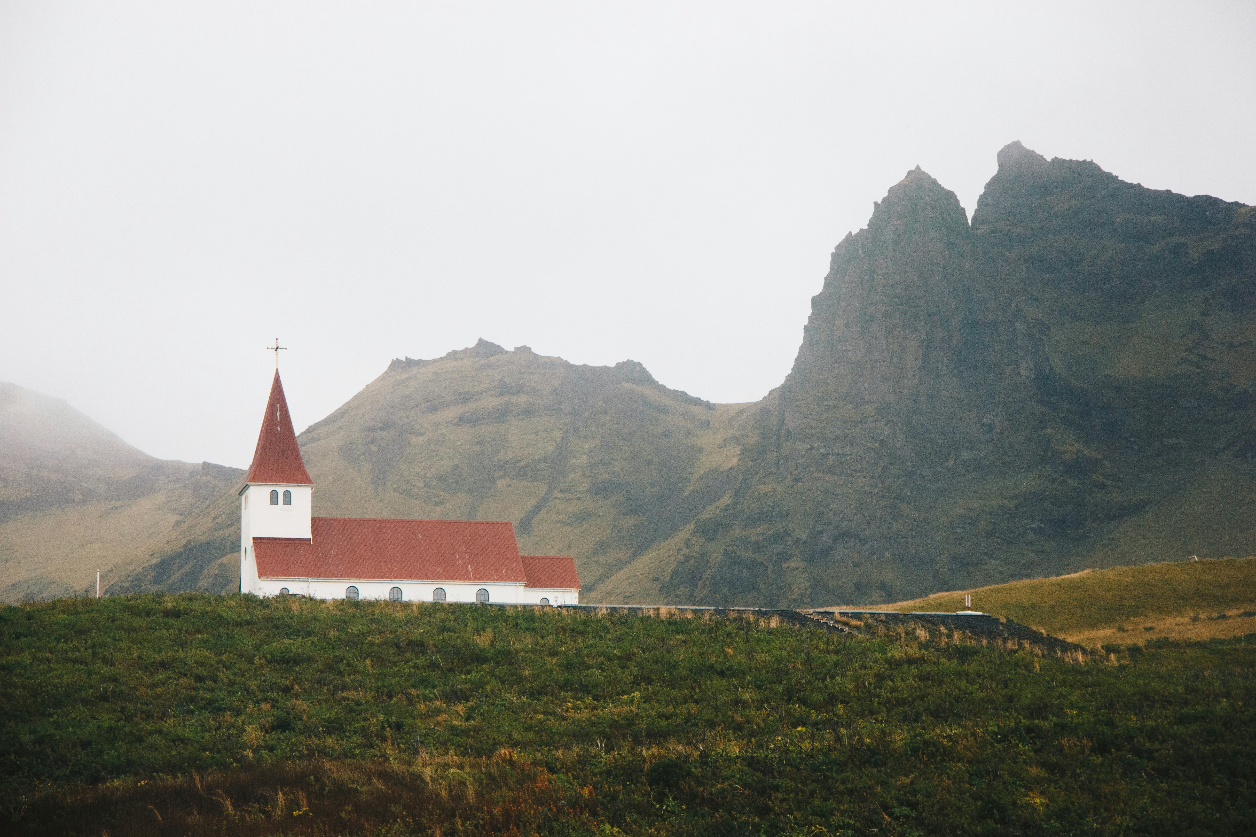 red and white church near mountain